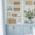 Dusty Blue Cabinetry with Brass Accents for Coastal Charm