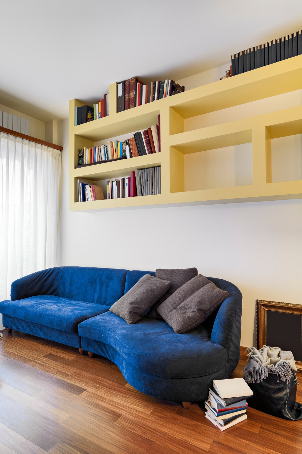 Living Room with Blue Velvet Sofa & Built-In Bookshelf