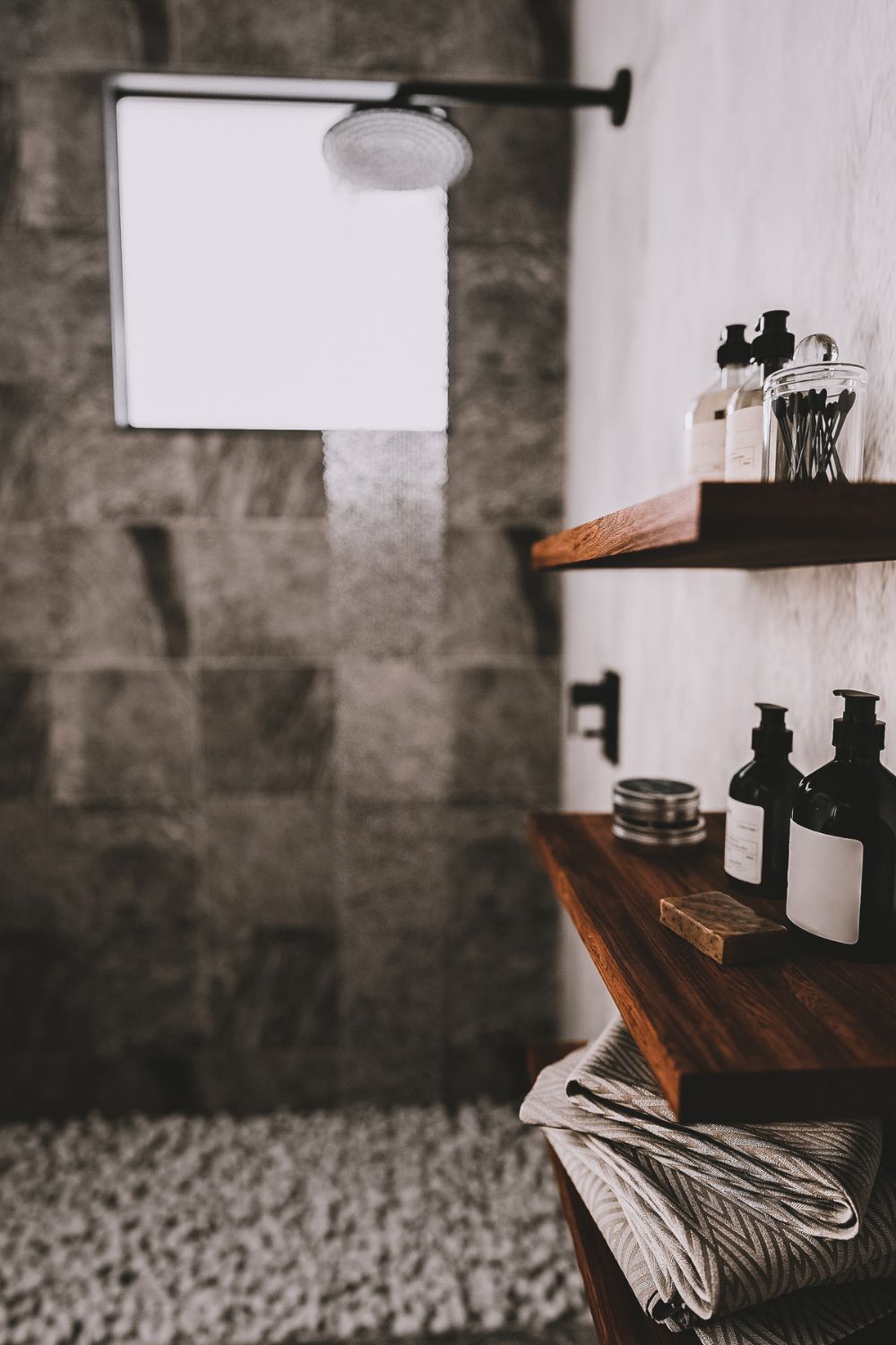 Stone Shower with Walnut Floating Shelves
